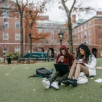 Douglas college scholarship man-and-woman-studying-at-a-park