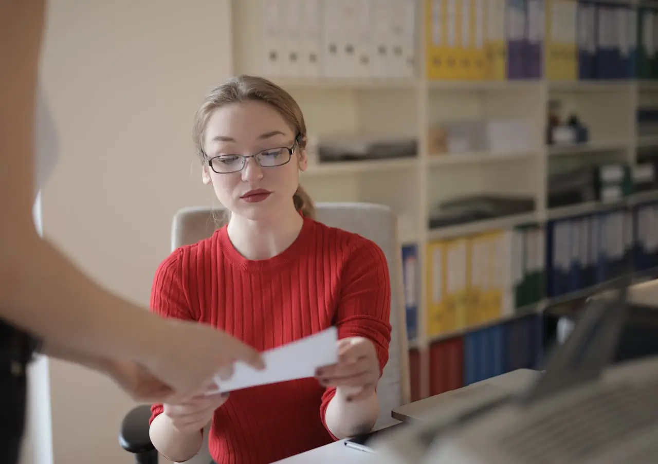 Human resources manager young-woman-examining-document-in-office