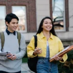 Undergraduate International Merit Scholarship young-man-and-woman-walking-together