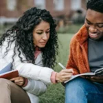 monash graduate scholarship cheerful-multiethnic-students-studying-together-in-campus-park