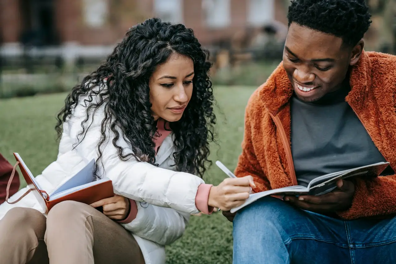 monash graduate scholarship cheerful-multiethnic-students-studying-together-in-campus-park