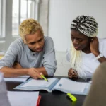 University of Manitoba Graduate Fellowship black-students-reading-assignment-in-textbook