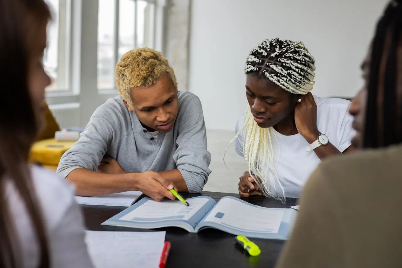 University of Manitoba Graduate Fellowship black-students-reading-assignment-in-textbook