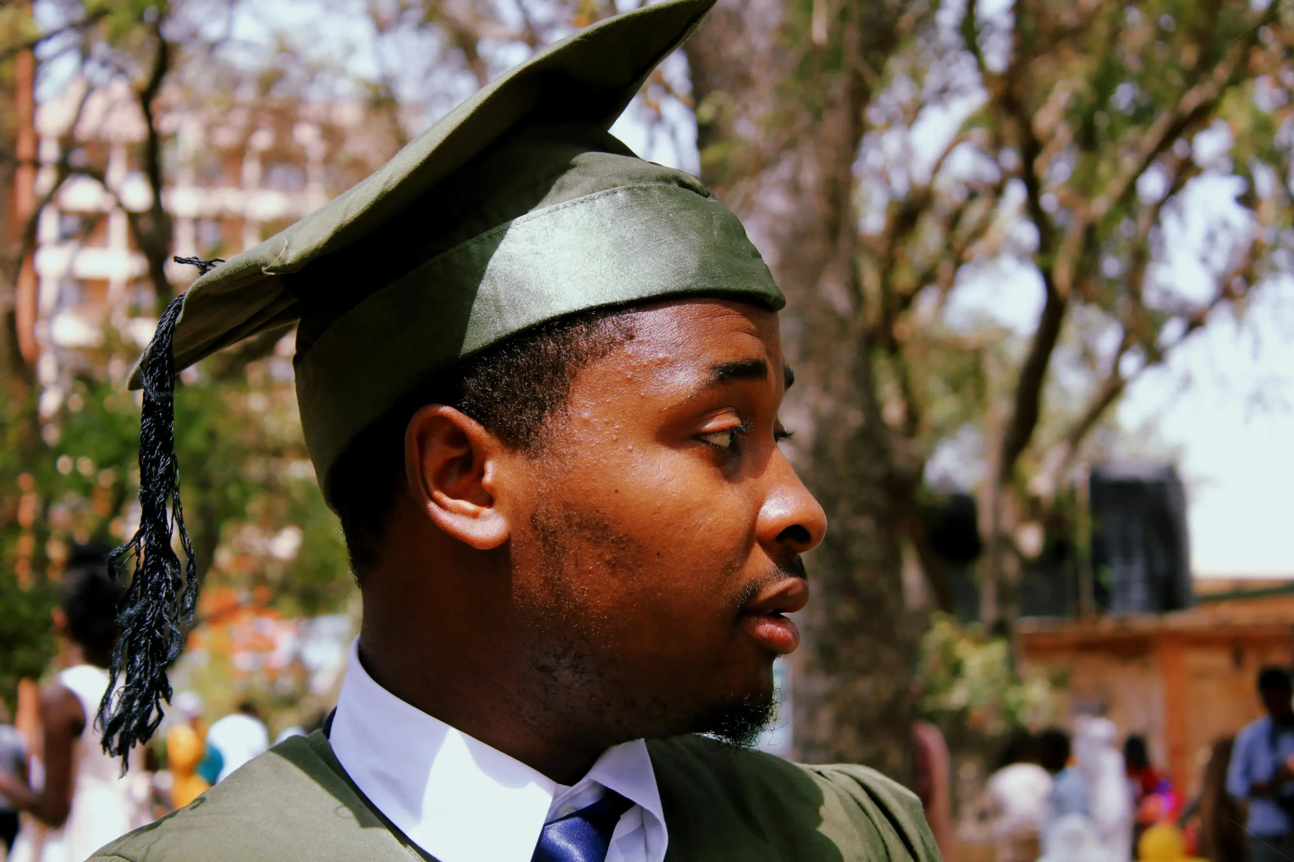 close-up-photo-of-a-global academic excellence scholarship man-wearing-green-academic-dress