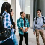 John Thompson Scholarship man-in-blue-dress-shirt-standing-beside-woman-in-gray-sweater