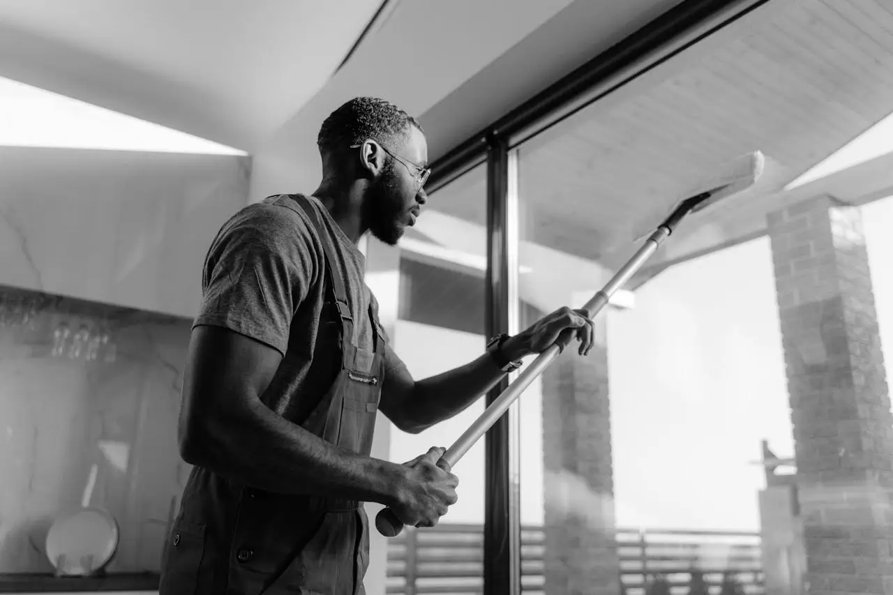 A home cleaners job-man-cleaning-a-glass-panel