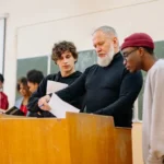 Graduate International Merit Scholarship students-and-teacher-in-the-classroom-near-brown-table