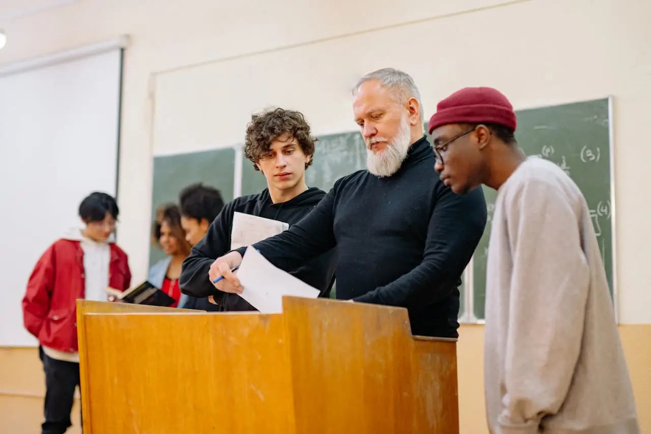 Graduate International Merit Scholarship students-and-teacher-in-the-classroom-near-brown-table