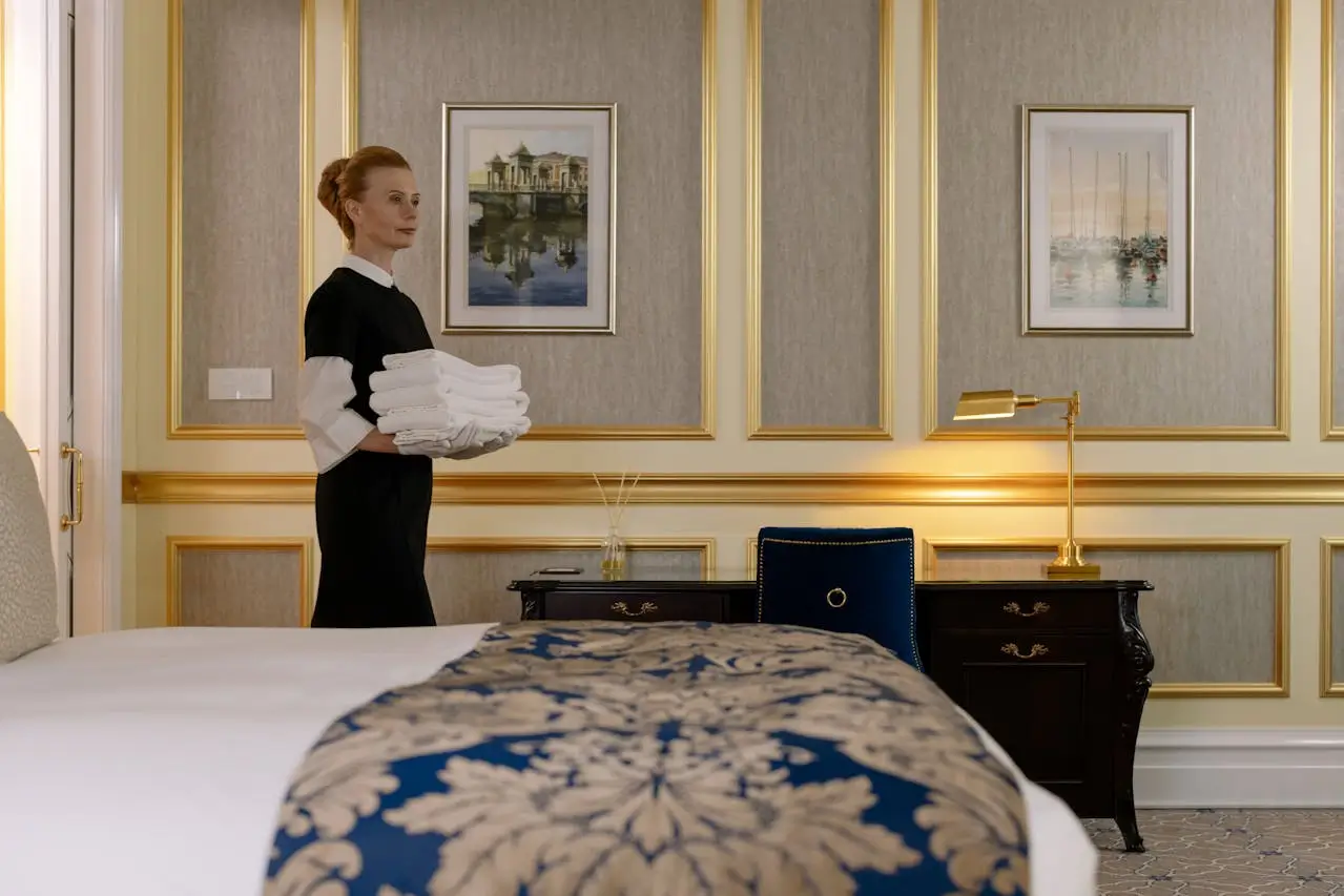 housekeeping supervisor job woman-carrying-a-stack-of-white-towels