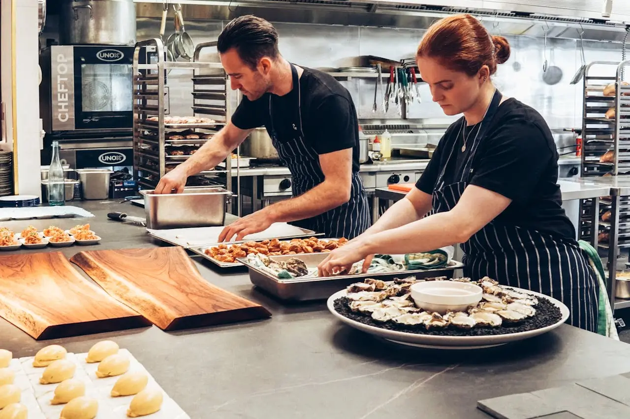 restaurant supervisor job man-and-woman-wearing-black-and-white-striped-aprons-cooking