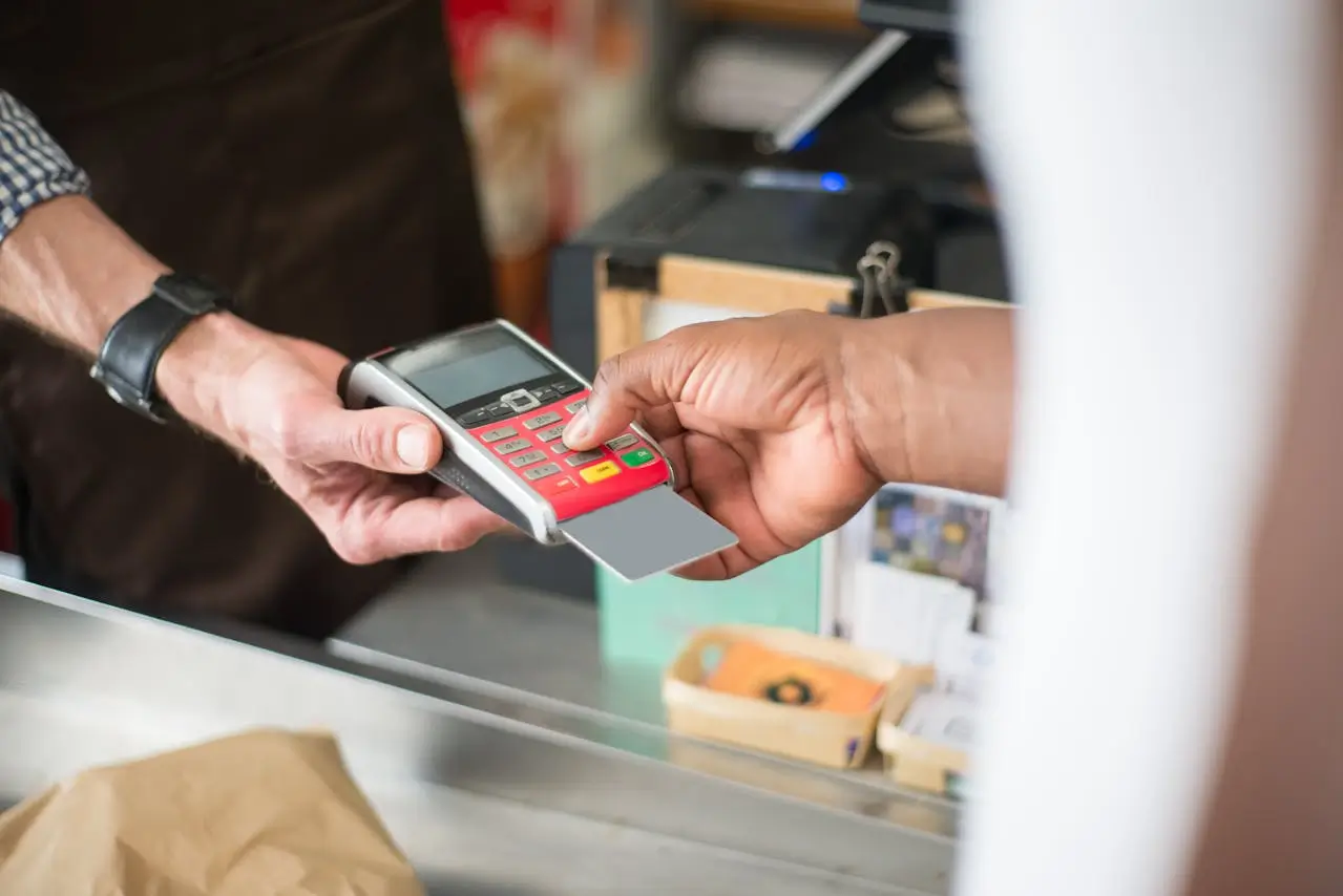 Cashier job person processing persons payment for a purchase