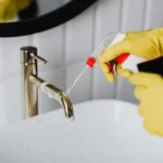 cleaner job woman-in-gloves-tiding-up-bathroom