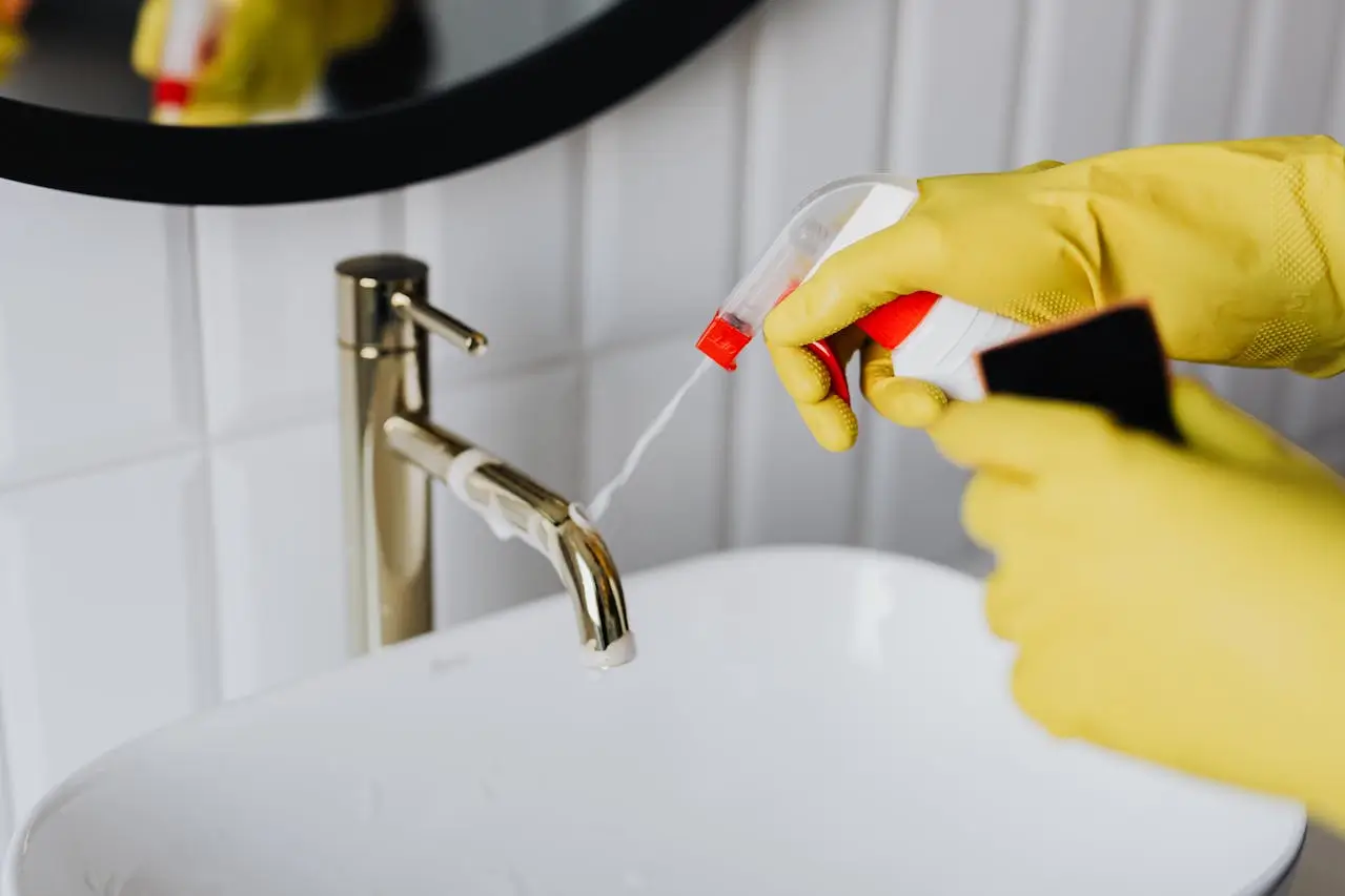 cleaner job woman-in-gloves-tiding-up-bathroom