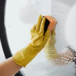 faceless housekeeper cleaning the glass