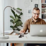 office administrator man-working with-macbook laptop computer