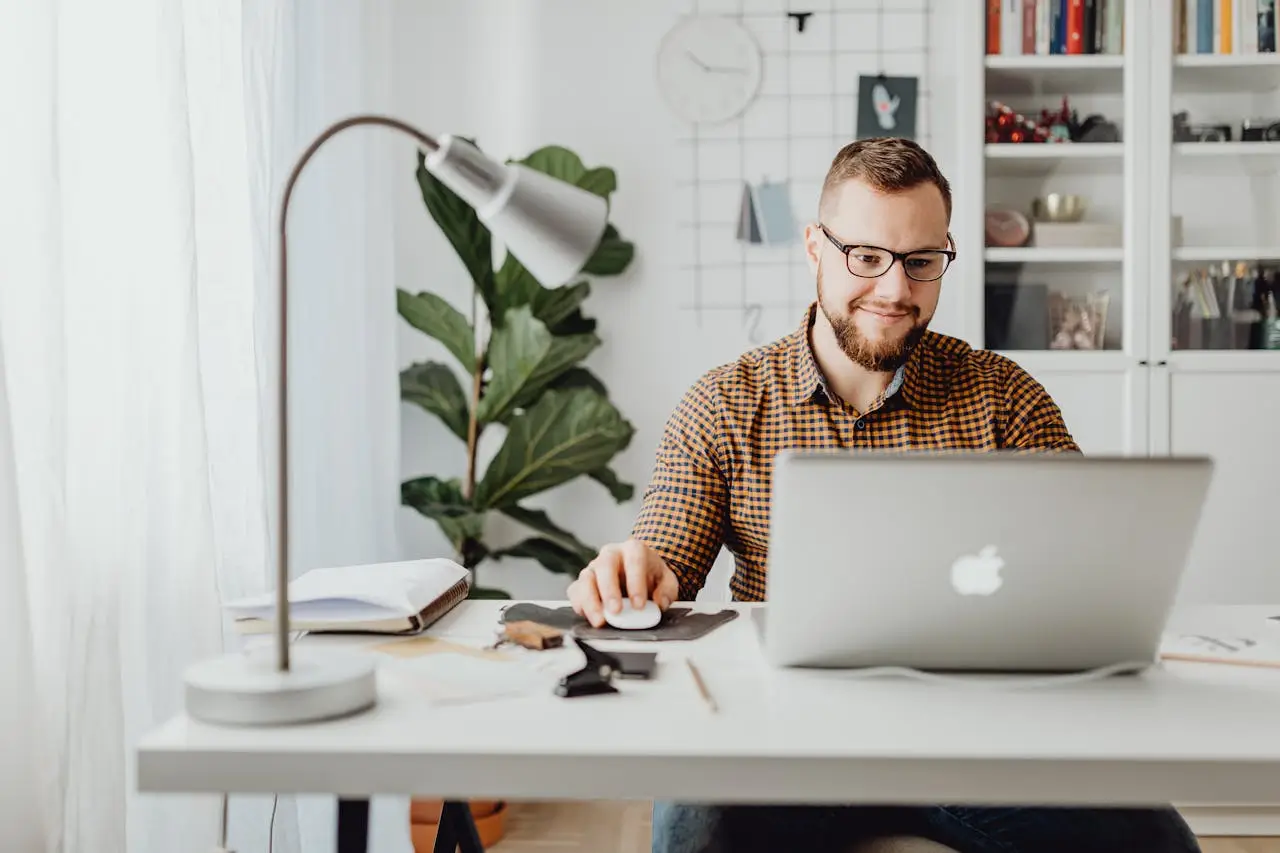 office administrator man-working with-macbook laptop computer