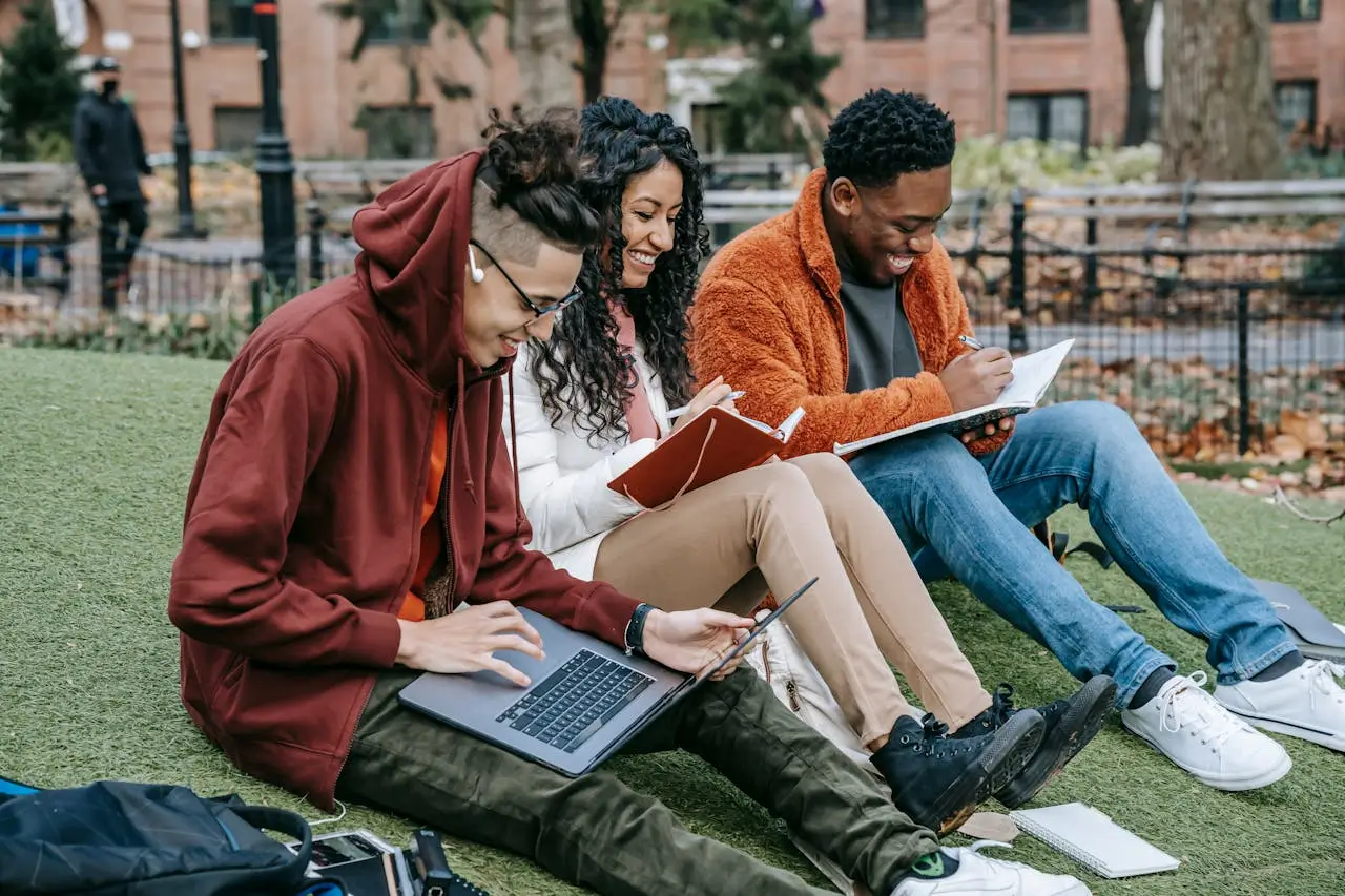 cheerful-diverse-Illinois Wesleyan University Scholarships classmates-studying-in-park