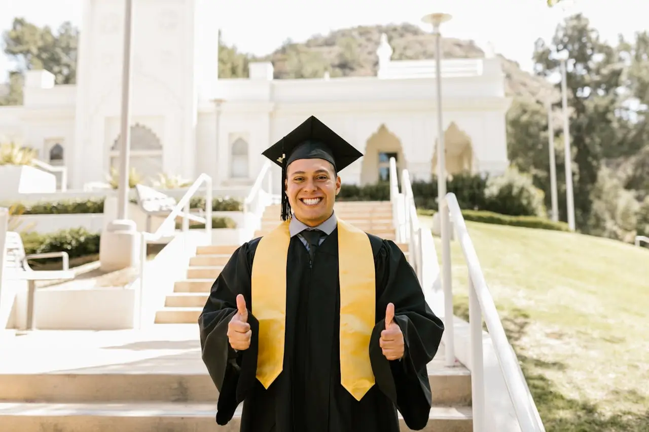 president's PhD scholarships man-wearing-graduation-gown-posing