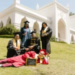 university of the arts london scholarship newly-graduate-students-wearing-toga-while-looking-at-the-camera