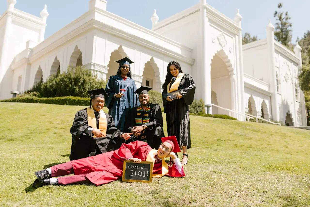 university of the arts london scholarship newly-graduate-students-wearing-toga-while-looking-at-the-camera