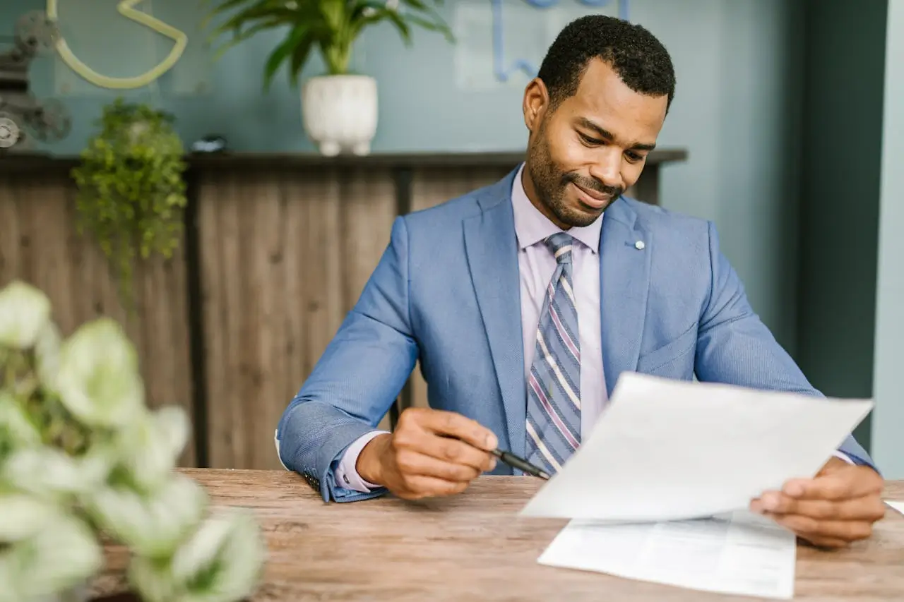 Purchasing Agent with paper in his office