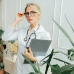 Hospitalist (Exempt) Job doctor-wearing-a-eyeglasses-and-holding-a-clipboard