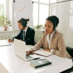 front desk agent man-and-woman-working-wearing-headsets.