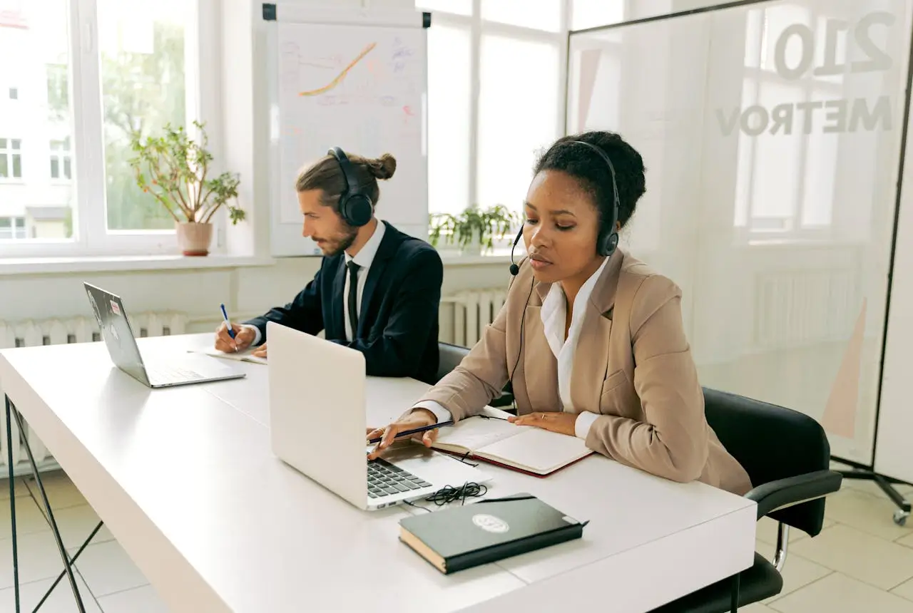 front desk agent man-and-woman-working-wearing-headsets.