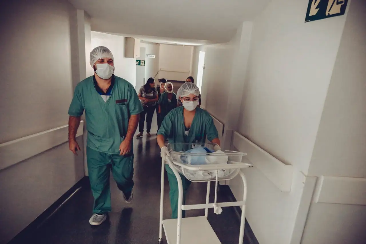 nurse-carrying-newborn-baby-trolley-in-hospital